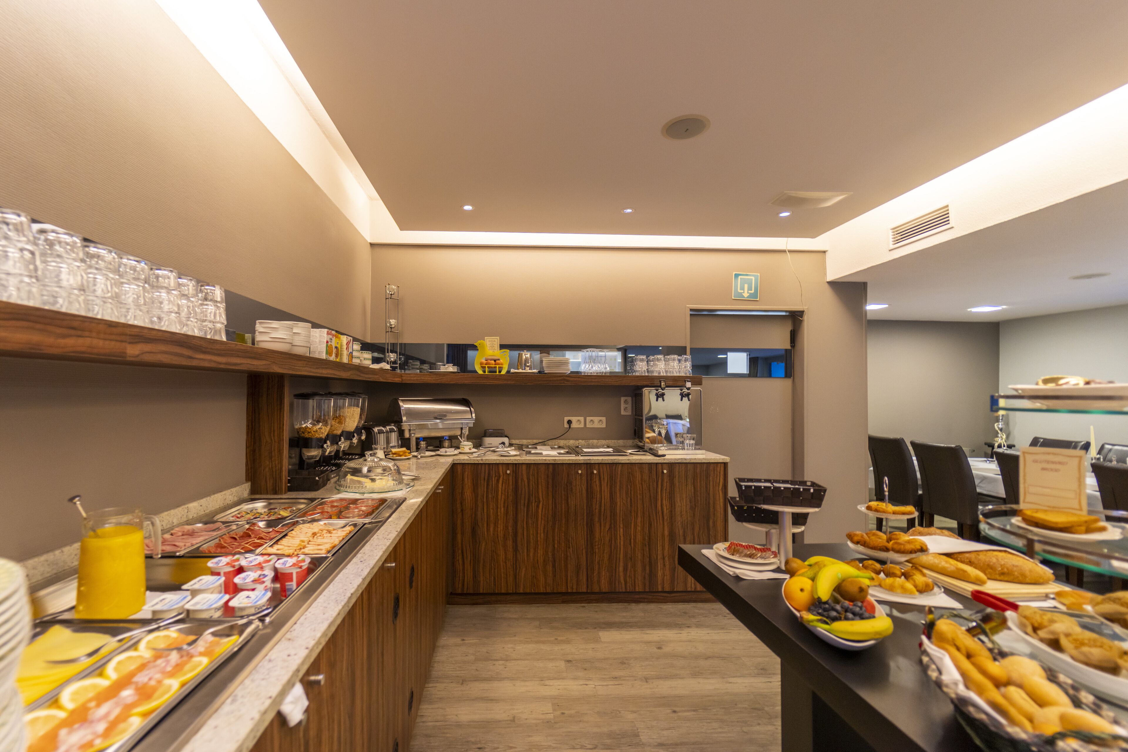 A buffet area with various food items and a coffee station.