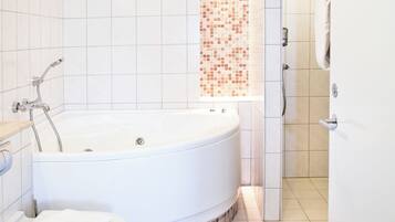 Junior Suite, Jetted Tub | Bathroom | Eco-friendly toiletries, hair dryer, heated floors, towels