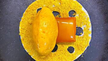 A yellow substance on a dark surface with a hole in the center.