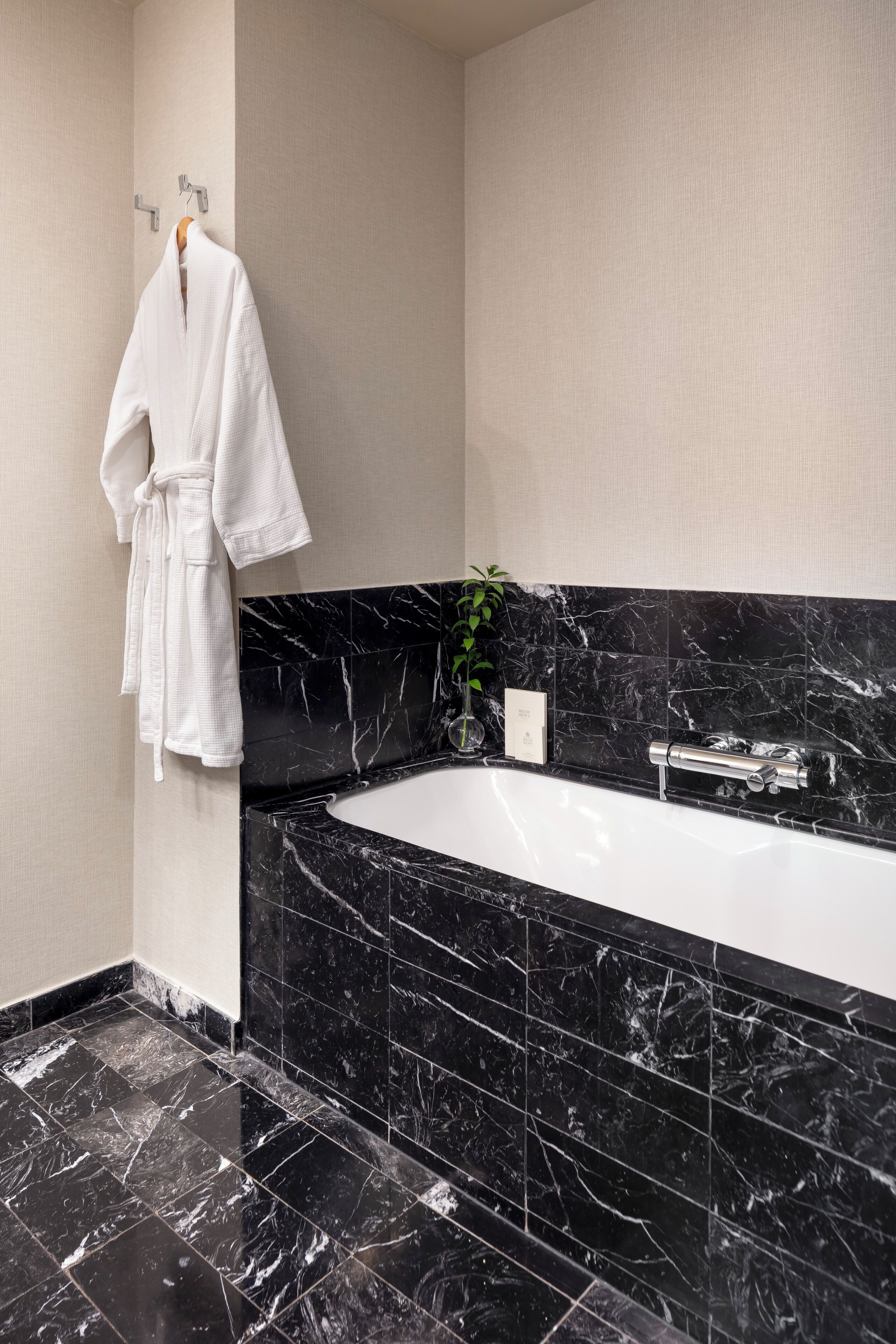 designer toiletries, hair dryer, slippers, towels