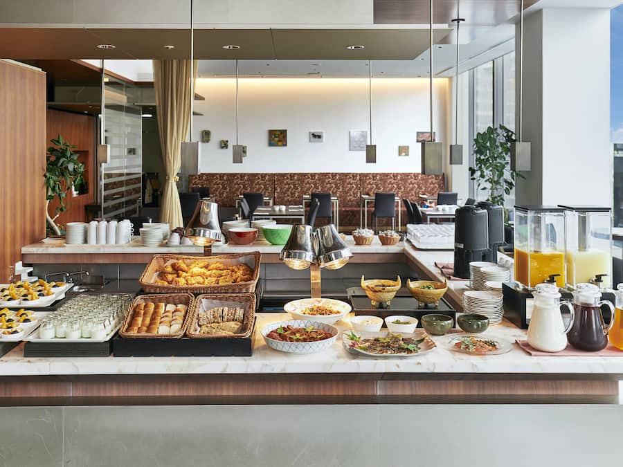 A buffet setup with various food items and beverages.