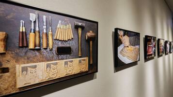 A display of woodworking tools and a framed artwork on a wall.