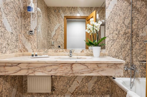 Bathtub, eco-friendly toiletries, hair dryer, towels