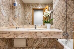 Bathtub, eco-friendly toiletries, hair dryer, towels