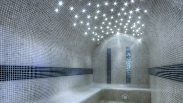Relax in a serene space with a curved ceiling, bench, and stained glass windows.