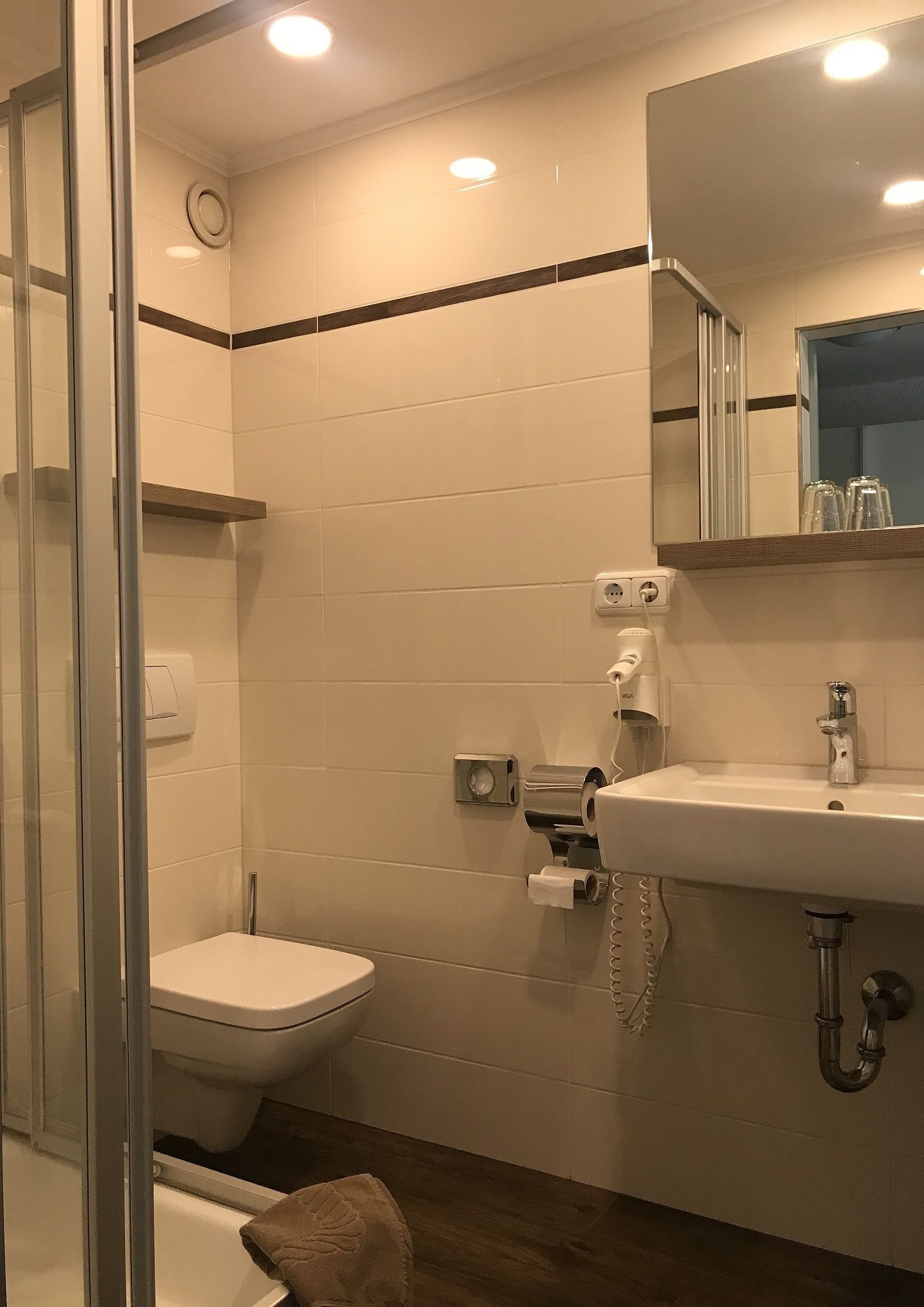 A bathroom with a toilet, sink, and shower.