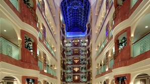A multi-level atrium with a central open space, multiple balconies, and a glass ceiling. - Madinah Hilton (Madinah)