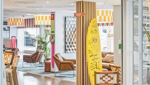 A breakfast setting with a variety of food items, including pastries, fruit, and beverages, arranged on a wooden table. - Hôtel AKENA Biarritz - Grande plage (Biarritz)