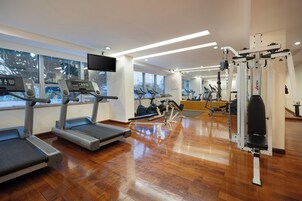 A gym with treadmills, elliptical machines, and weight equipment.