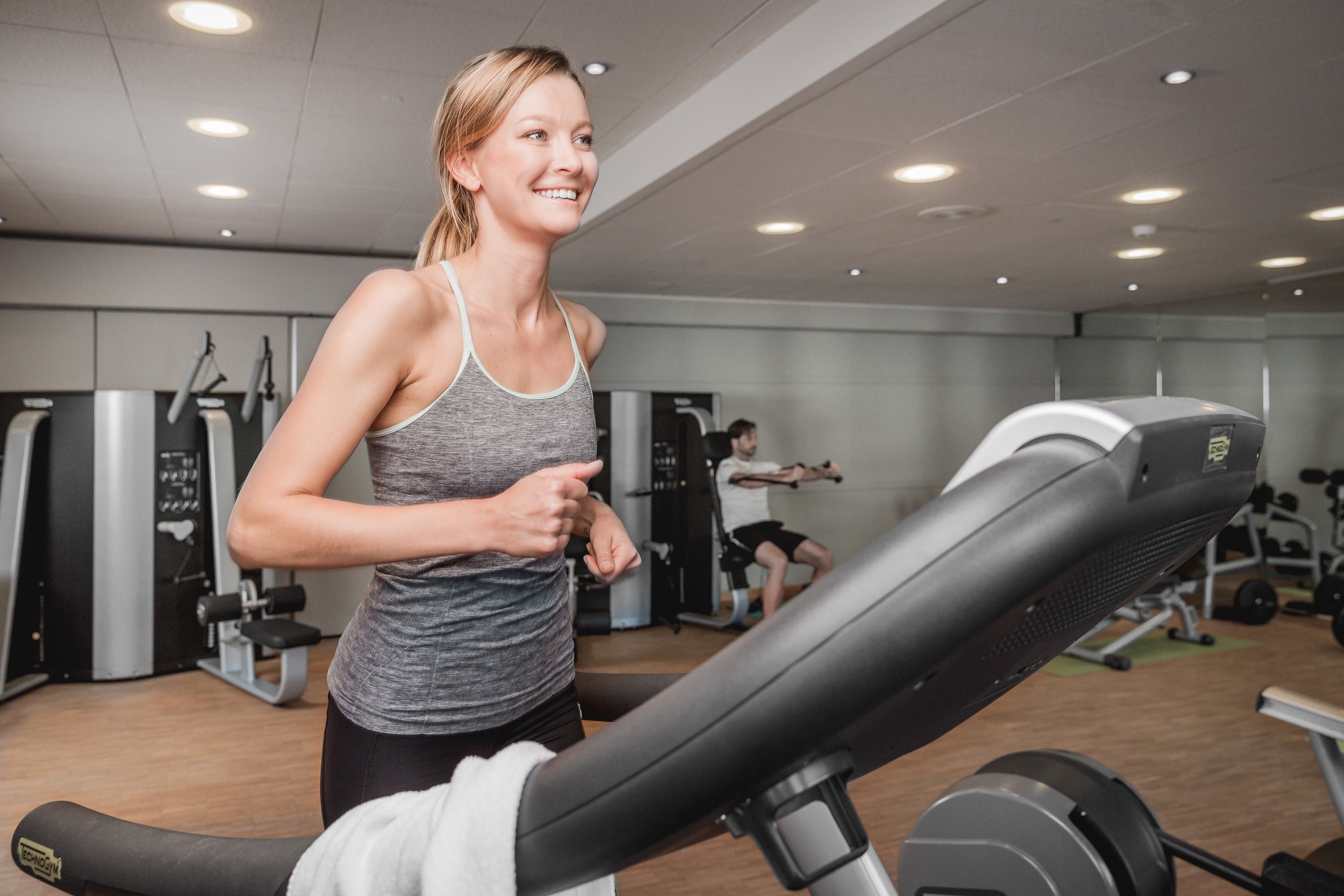 A gym with exercise equipment, including treadmills and weight machines.