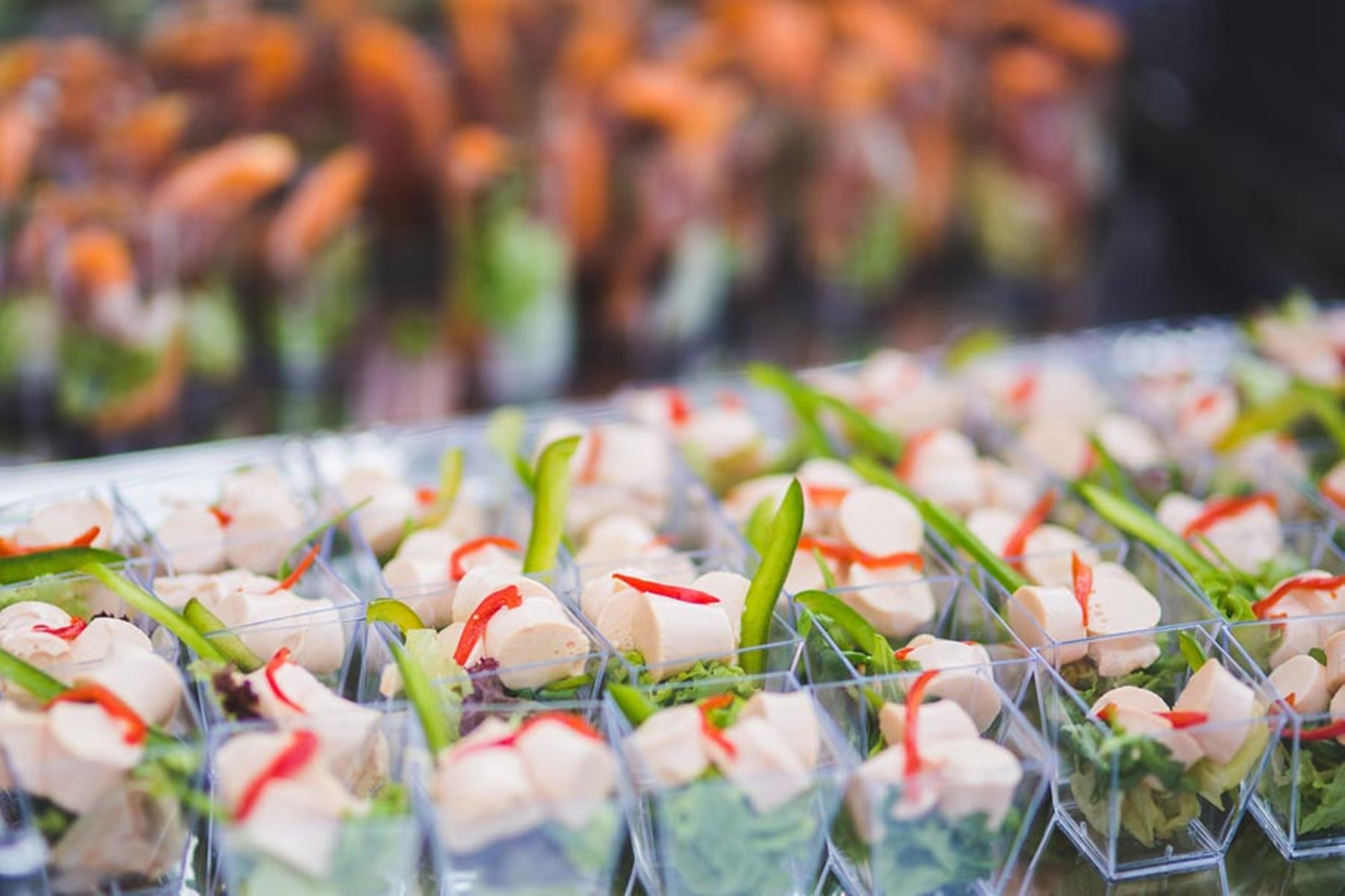 A close-up of food arranged in clear containers, possibly for a buffet or catering event.