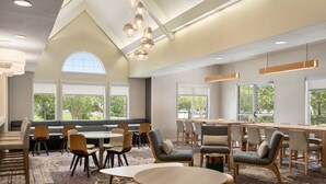 A spacious dining area with high ceilings, large windows, and modern lighting fixtures. - Residence Inn by Marriott Houston Northwest/Willowbrook. (Houston)