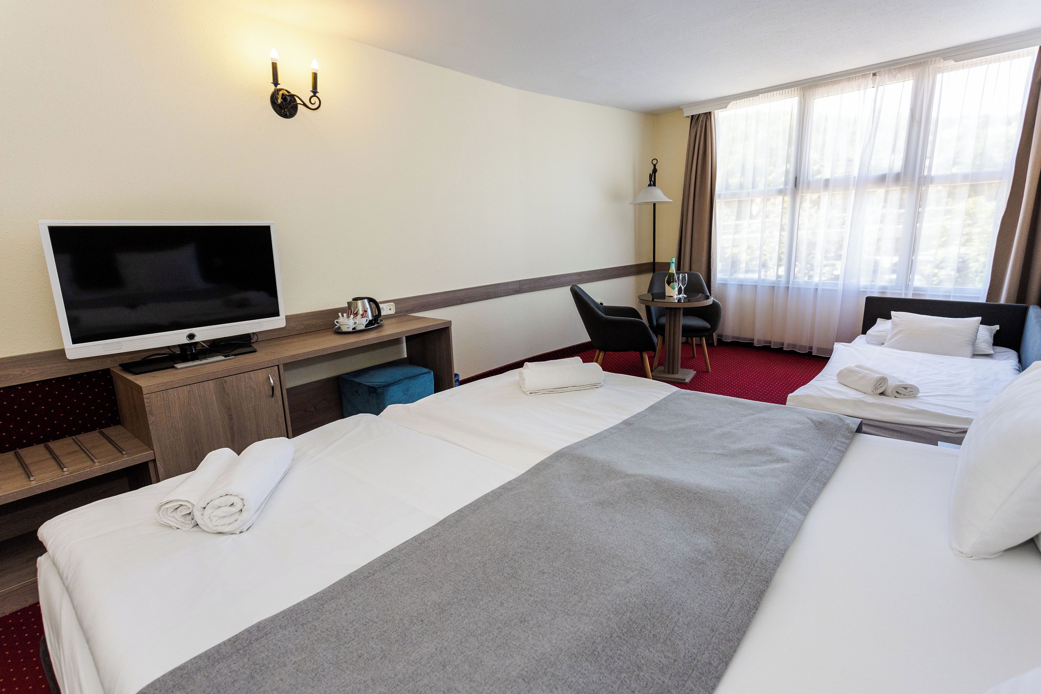 Triple Room | Minibar, in-room safe, desk, blackout curtains