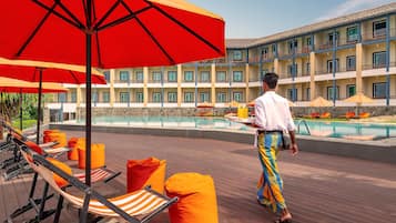 Relax by the pool surrounded by comfortable lounge chairs and bean bag chairs on the deck.