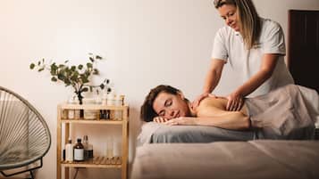 Experience a tranquil spa setting with a soothing massage, surrounded by calming ambiance and serene surroundings.
