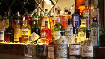 A variety of liquor bottles displayed on a bar counter.