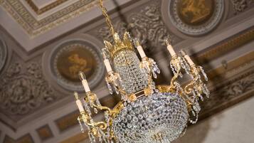 A chandelier with multiple arms and crystal decorations.