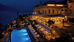 Een hotel met een zwembad, terras en uitzicht op zee.