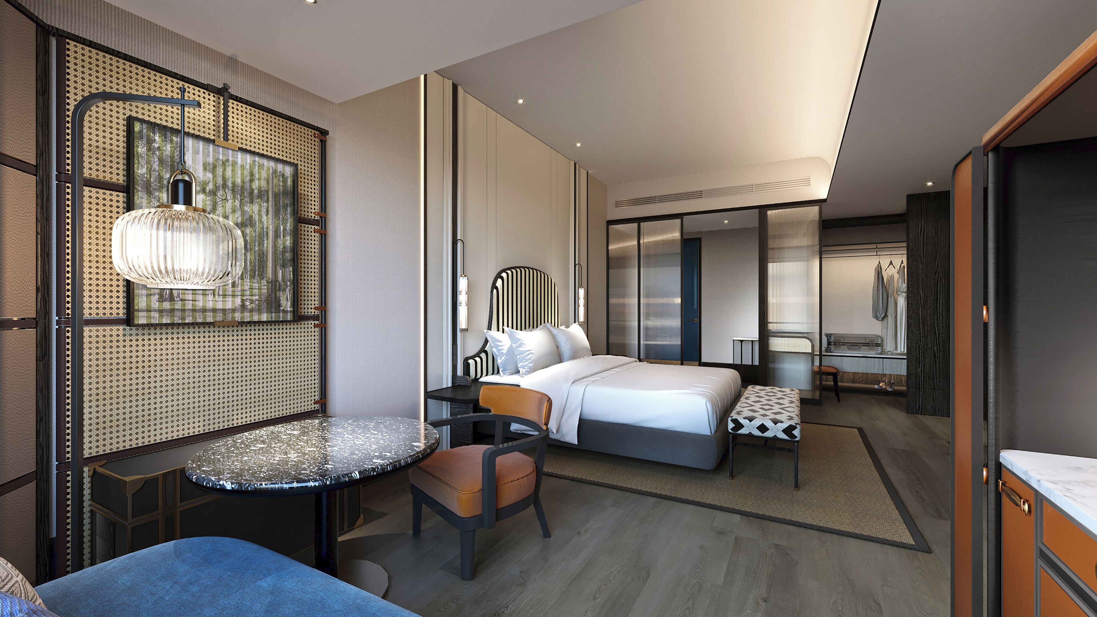 Una habitación de hotel moderna con una cama grande, una zona de estar con una mesa y sillas, un armario y un espejo.
