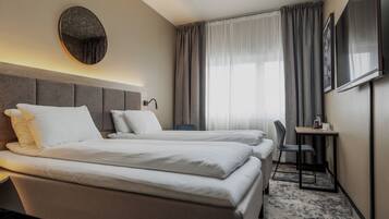 Desk, laptop workspace, bed sheets, wheelchair access