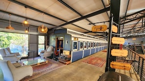 A train-themed restaurant with a dining area, a pool bar, and a swimming pool. - Safari Hotel & Convention Centre (Rustenburg)
