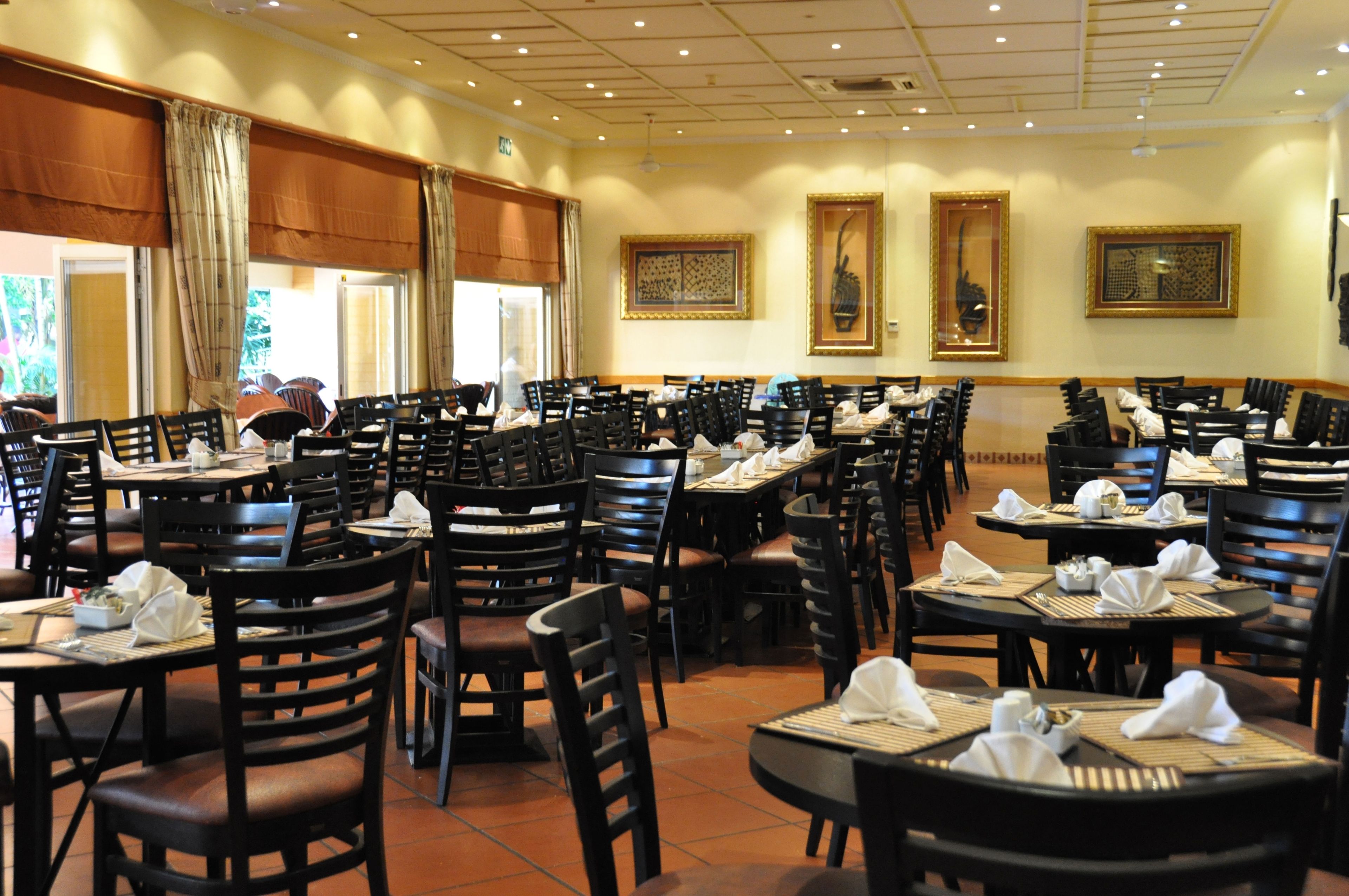 Un restaurant doté de nombreuses tables et chaises, disposées en rangées.