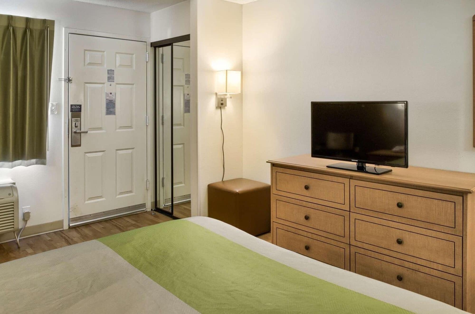 Desk, laptop workspace, alarm clocks, bed sheets