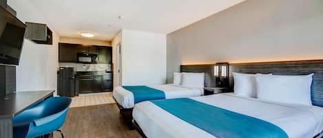 Laptop workspace, bed sheets, alarm clocks