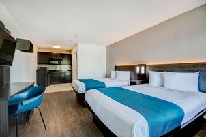 Laptop workspace, bed sheets, alarm clocks