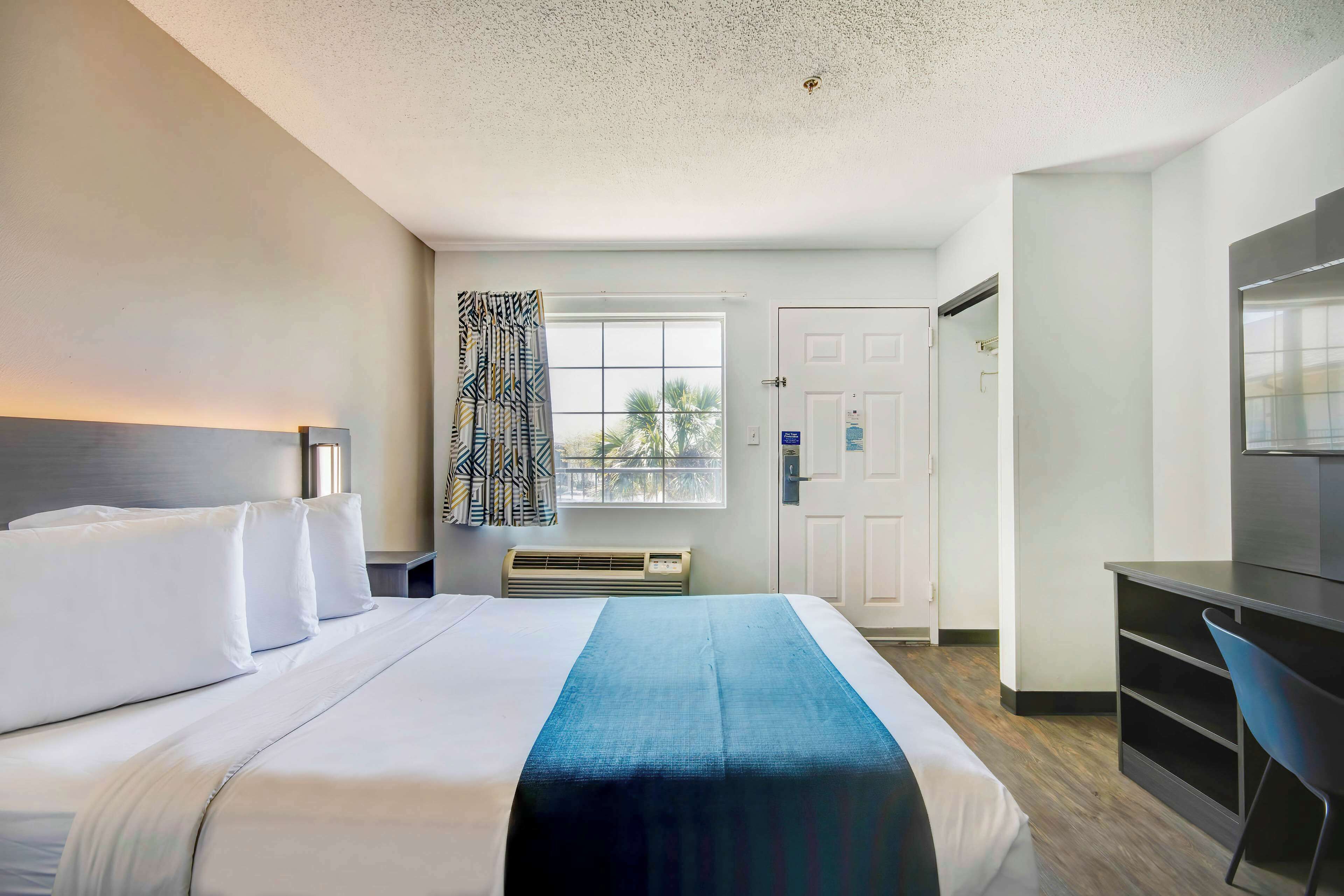 Laptop workspace, bed sheets, alarm clocks