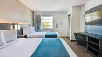 Laptop workspace, bed sheets, alarm clocks