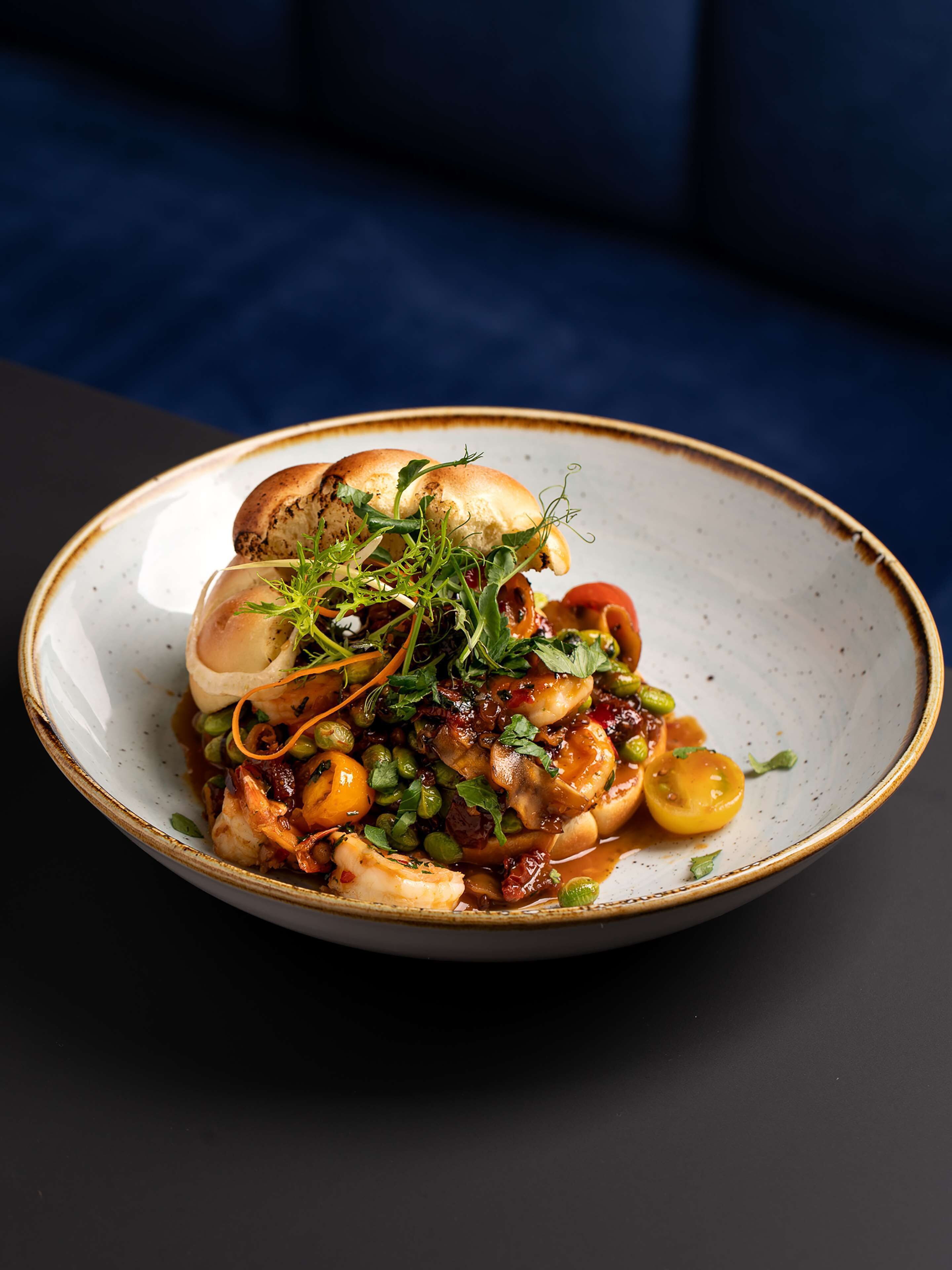 A plate of food with various ingredients and garnishes.