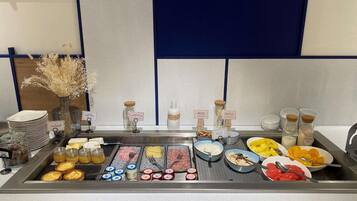 A buffet setup with various food items and condiments.