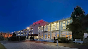 A hotel with a prominent 'Mercure' sign, large windows, and a covered entrance area. - Mercure Rouen Val De Reuil (Val-de-Reuil)