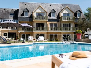 Outdoor pool, open 7:00 AM to 9:00 AM, pool umbrellas, pool loungers