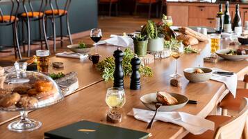 A dining table set with various dishes, glasses, and a menu.