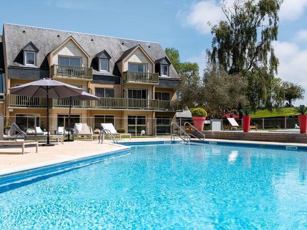 Outdoor pool, open 9:00 AM to 9:00 PM, pool umbrellas, pool loungers