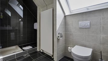 A modern bathroom with a shower, toilet, and a towel rack.