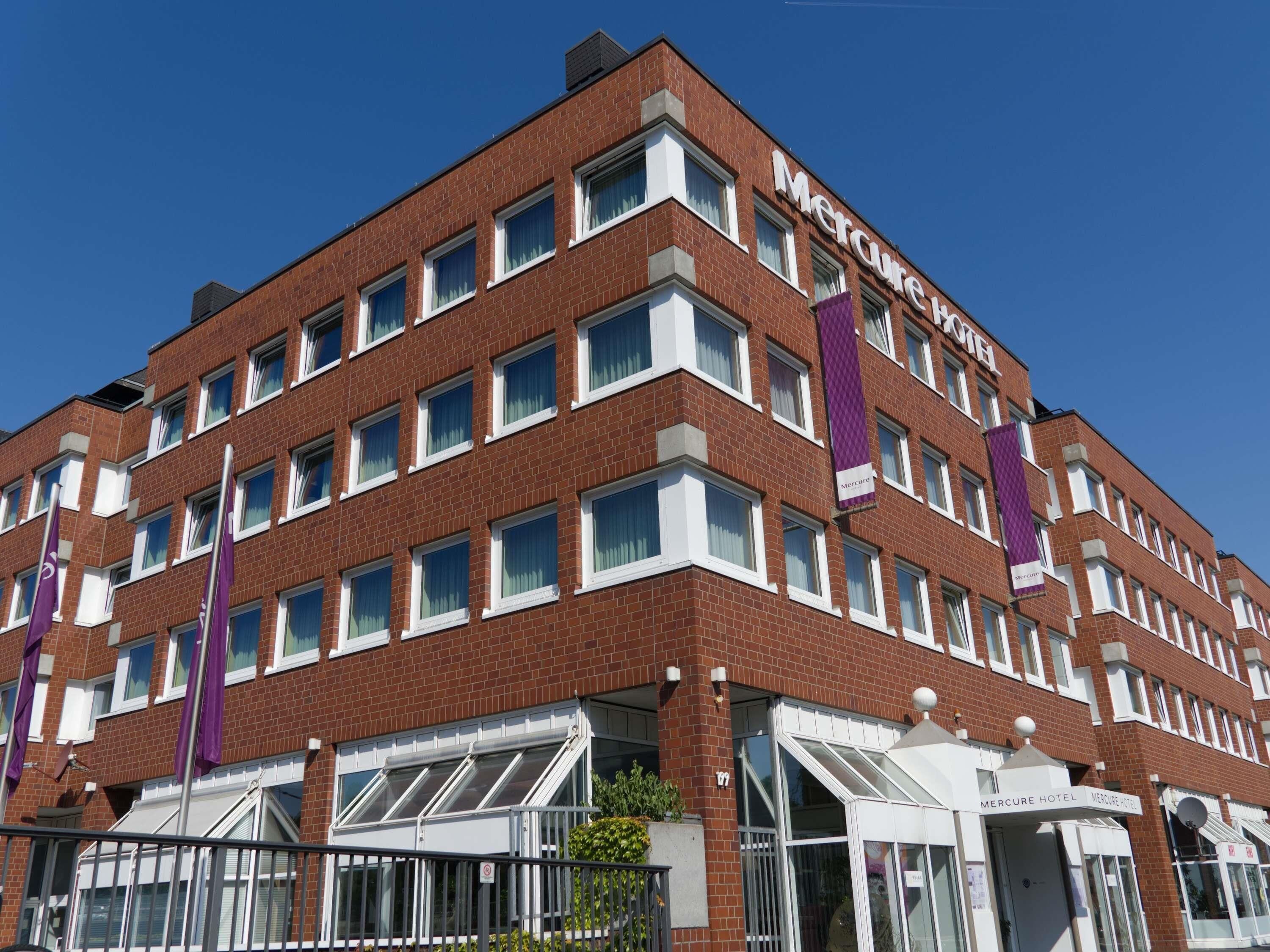 A multi-story brick building with the name 'Mercure Hotel' on the facade.