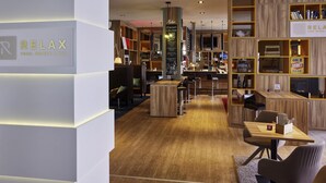 Un espace bar moderne avec des étagères en bois, des sièges et un comptoir.
