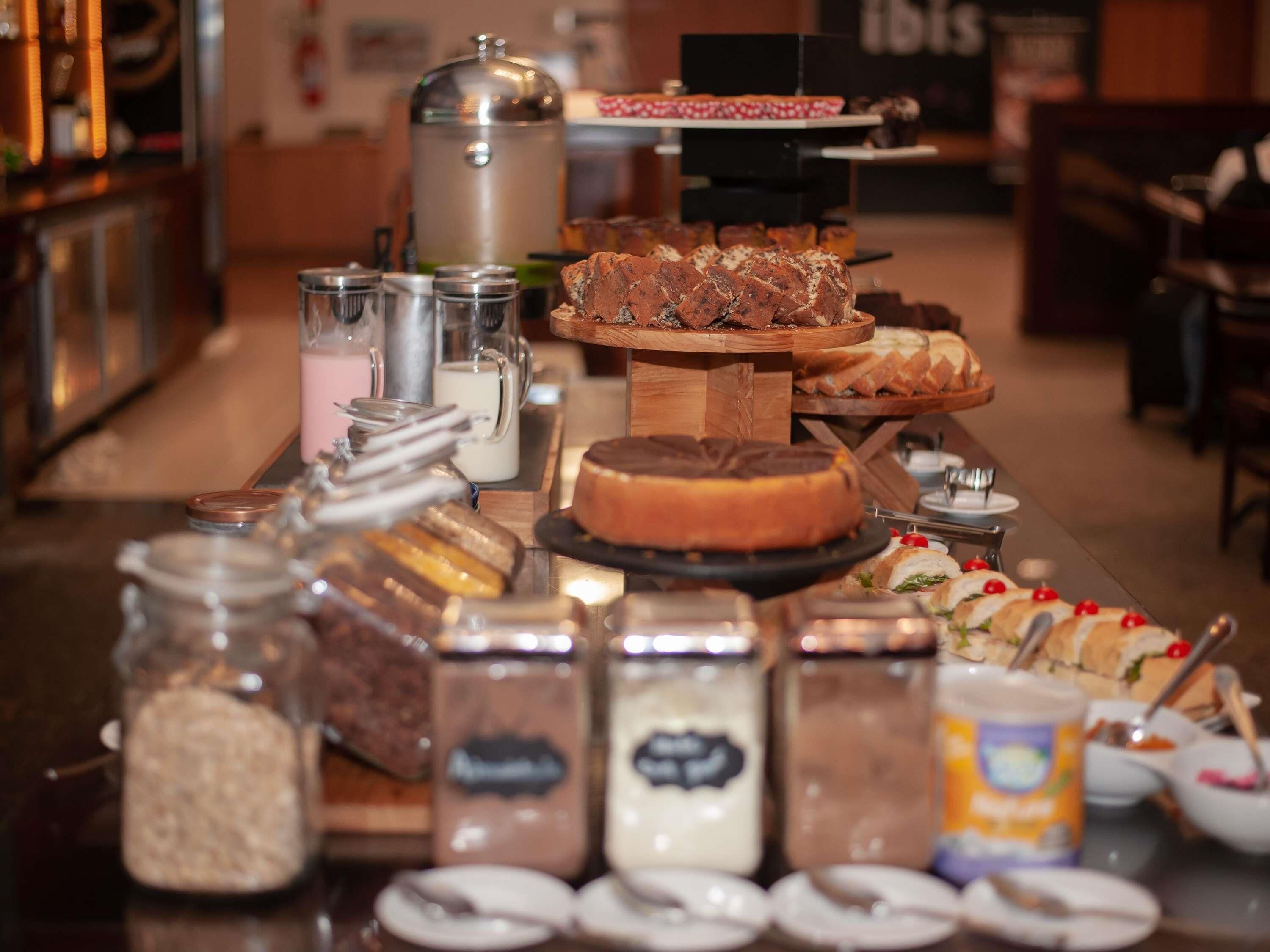 A buffet with various food items and condiments.