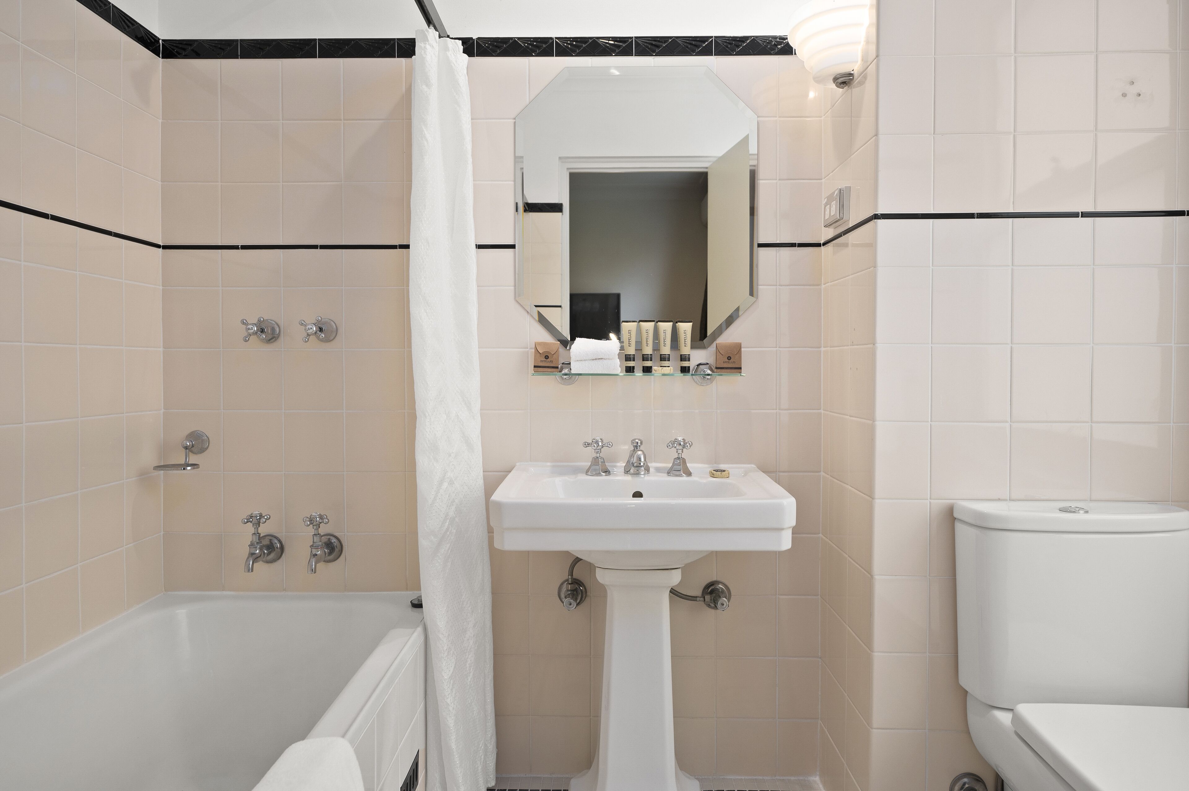 A bathroom with a bathtub, a sink, and a toilet.