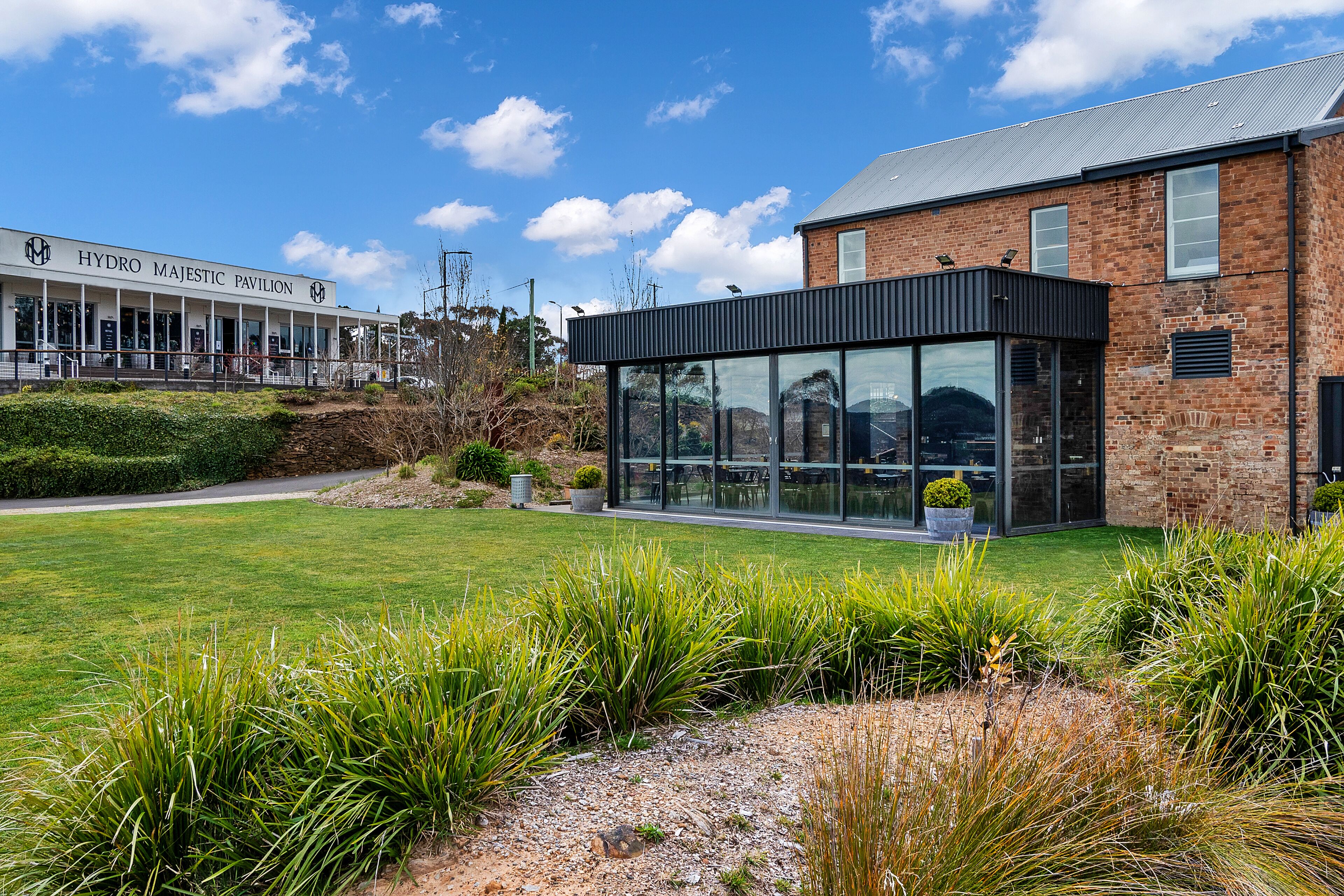A modern building with a glass facade and a sign reading "HYDRO MAJESTIC PAVILION".