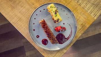 Un piatto dessert con diversi elementi su un tavolo di legno.
