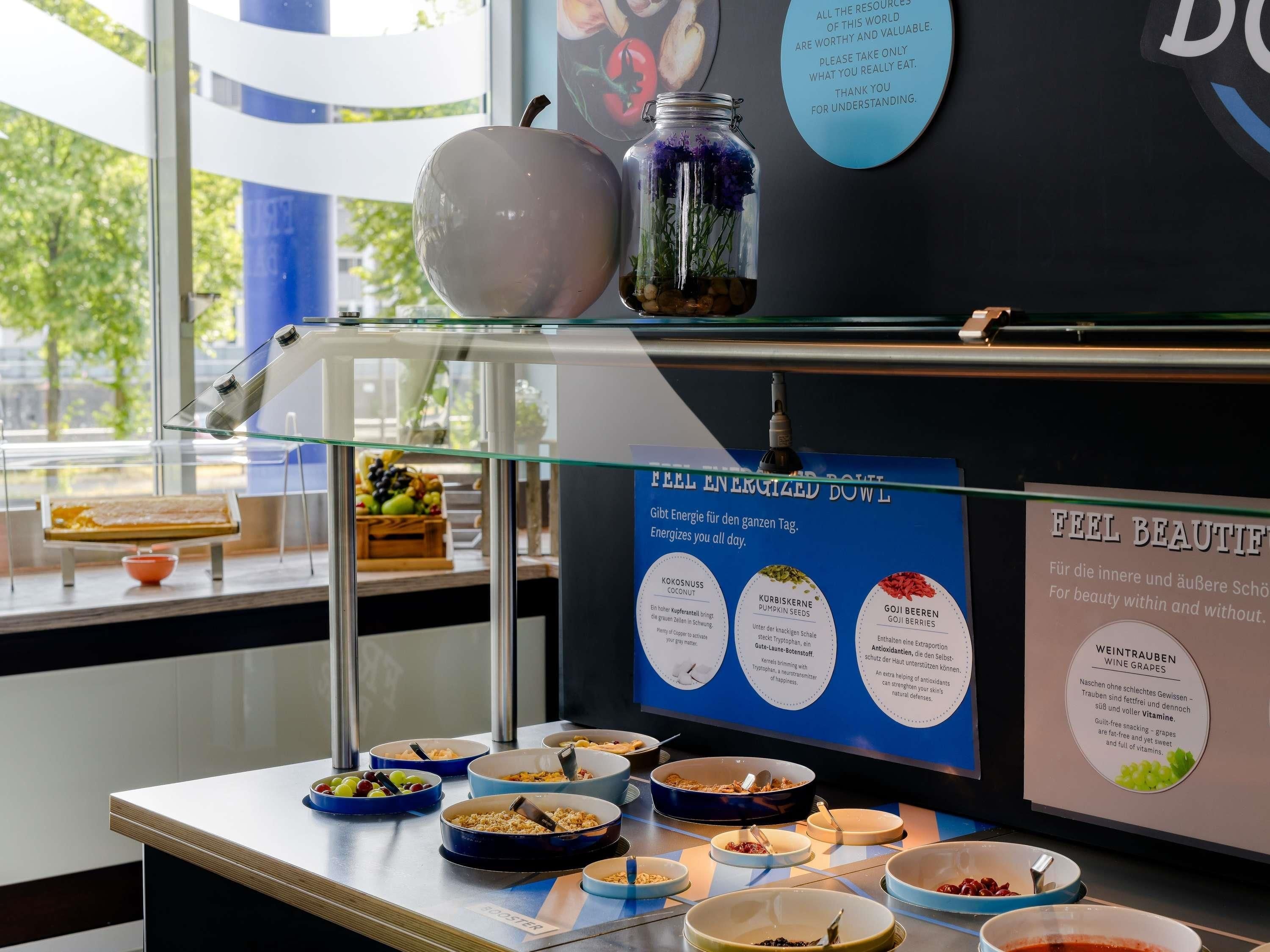 A buffet area with various food items and informational posters.