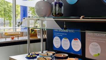 A buffet area with various food items and informational posters.