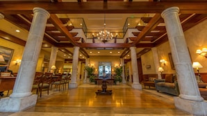 A spacious lobby with high ceilings, wooden beams, and a central chandelier. - Ponte Vedra Inn & Club (Ponte Vedra Beach)