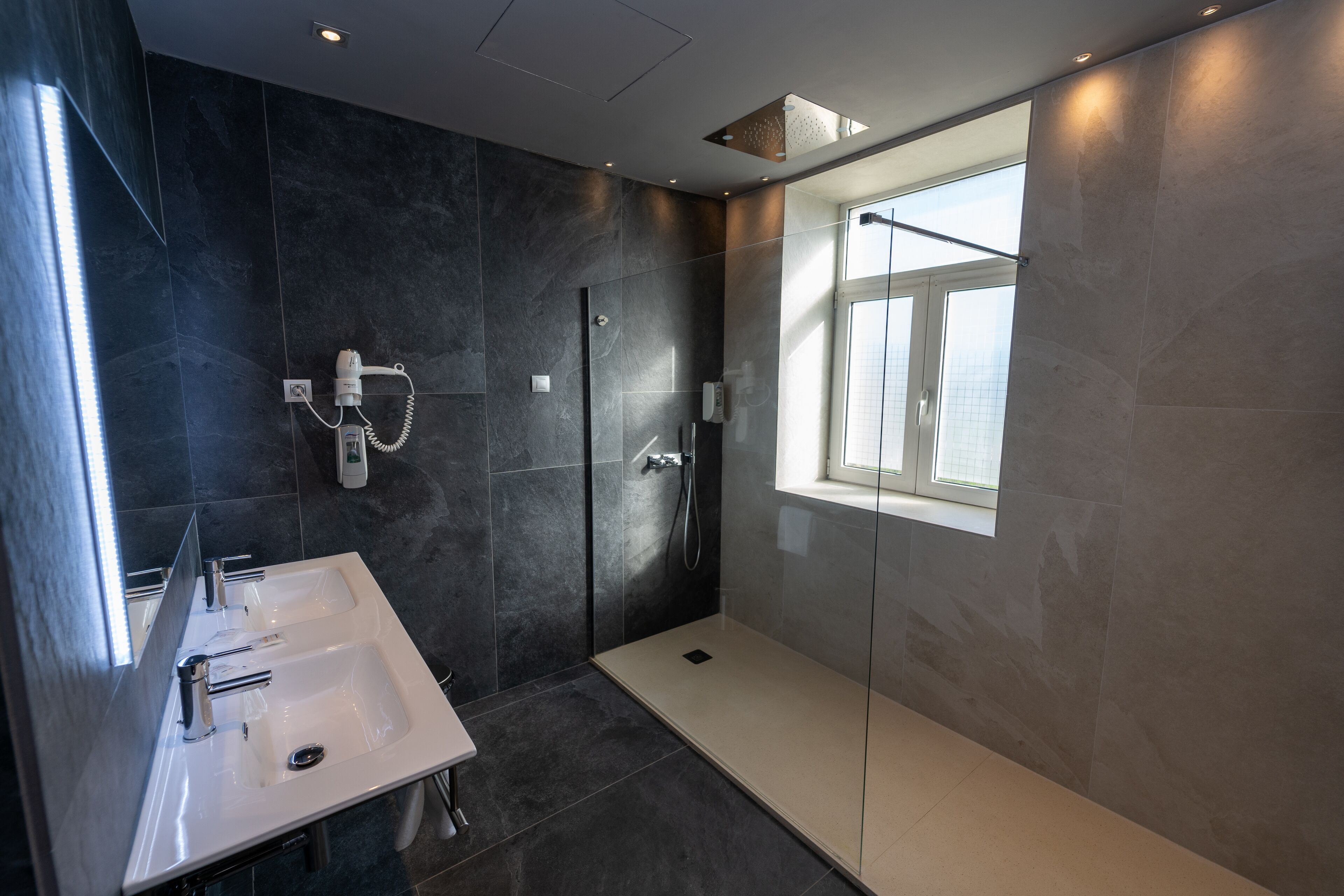 chromotherapy junior suite | bathroom | rainfall showerhead, free toiletries, hair dryer, towels