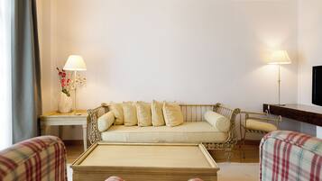 A living room with a sofa, two lamps, a TV, and a coffee table.