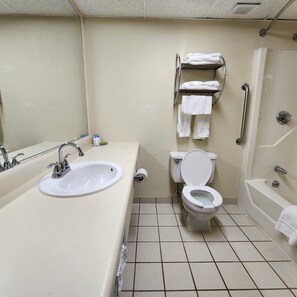 A bathroom with a sink, toilet, and bathtub.